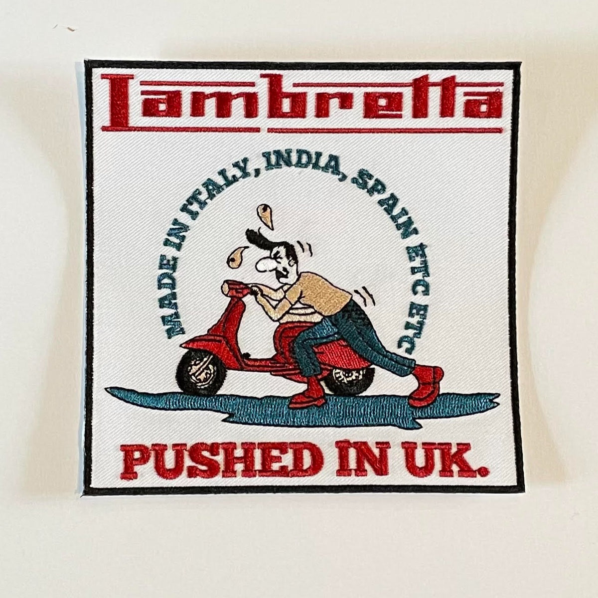 Lambretta Humour - 'Made in Italy, India, Spain, etc, etc....pushed in the UK' - Embroidered Patch